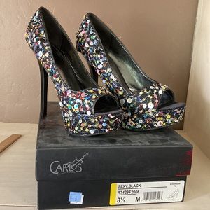 Never worn. Unique sequence platform heels.